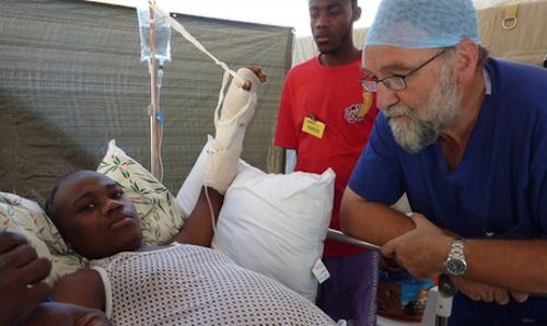 Prof Tony Redmond tending to a patient