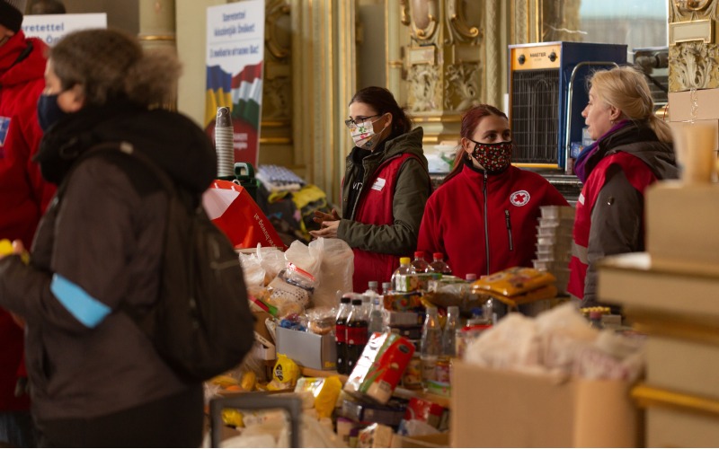 Female Red Cross workers providing aid.