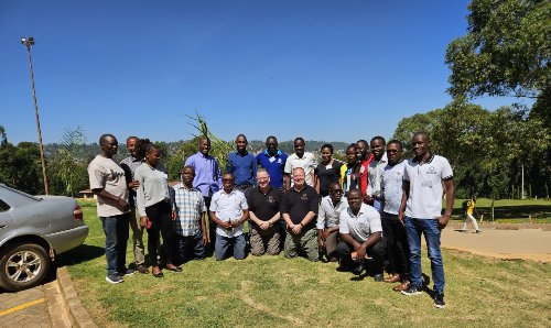 Kisii County ambulance team and trainers smiling and posing for photograph outside.